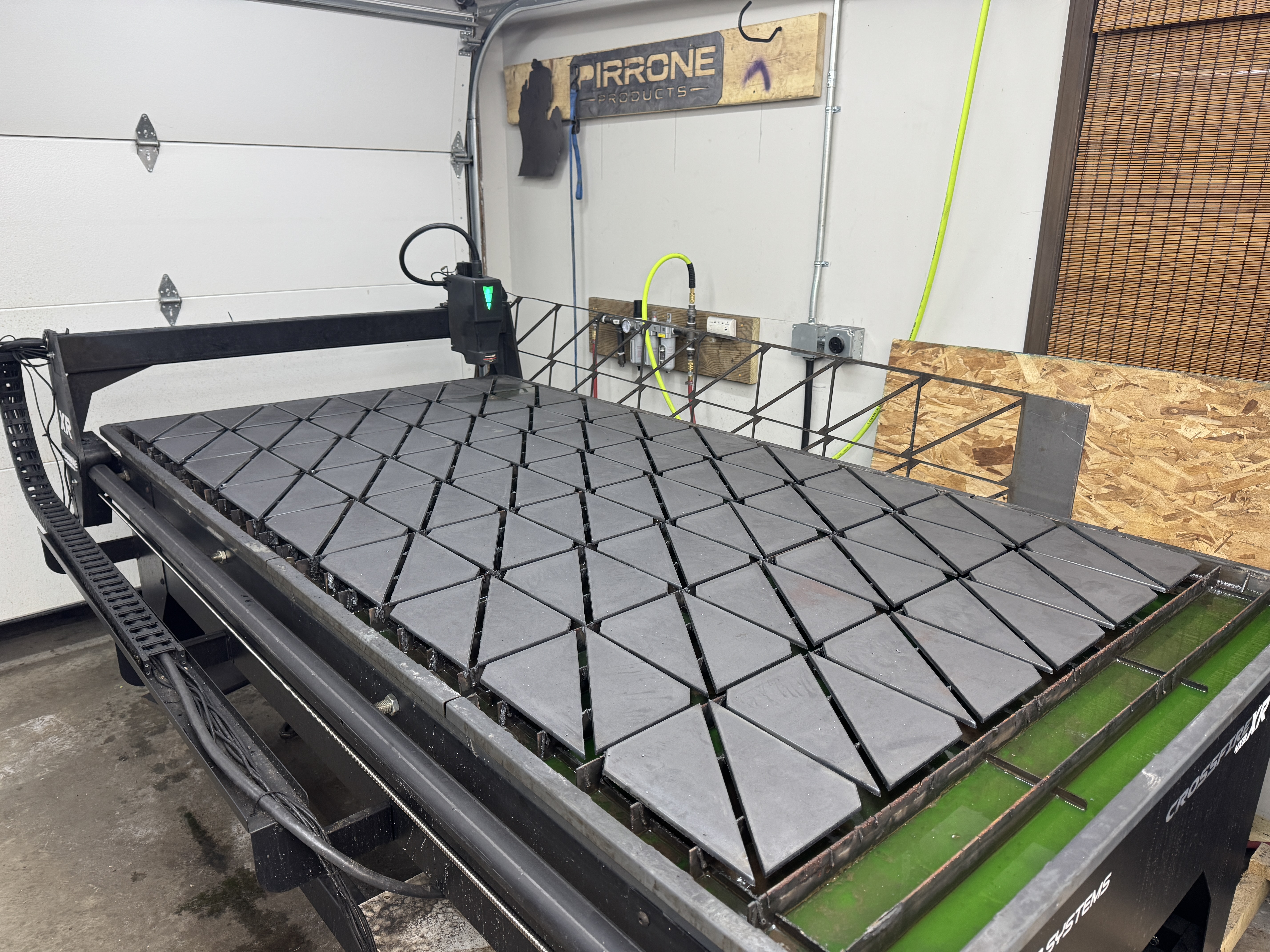 CNC-profiled steel components on the Pirrone Products cutting table