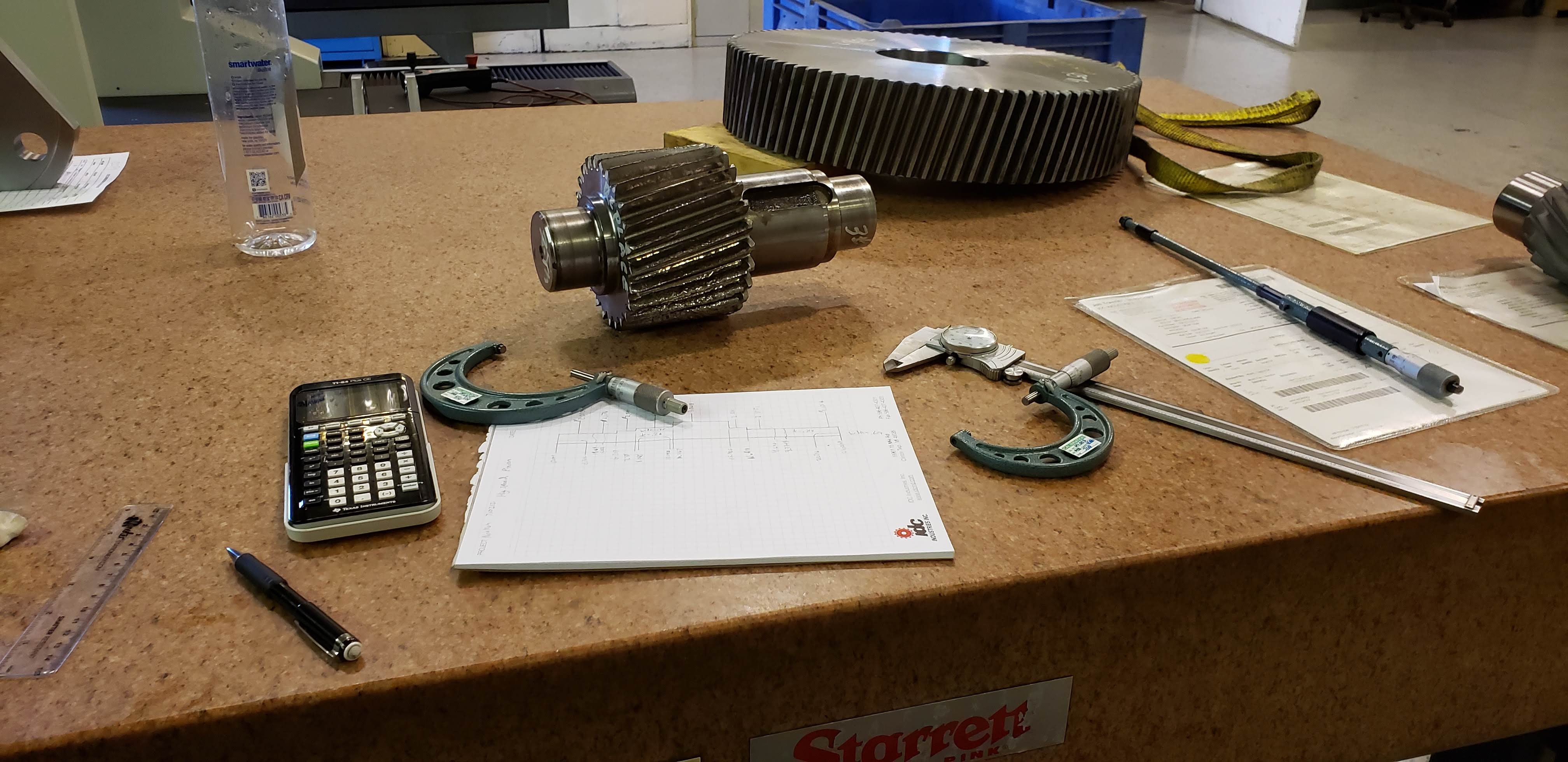Gear shaft being measured with precision inspection tools